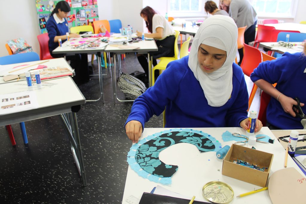 School children work on craft activities during a workshop