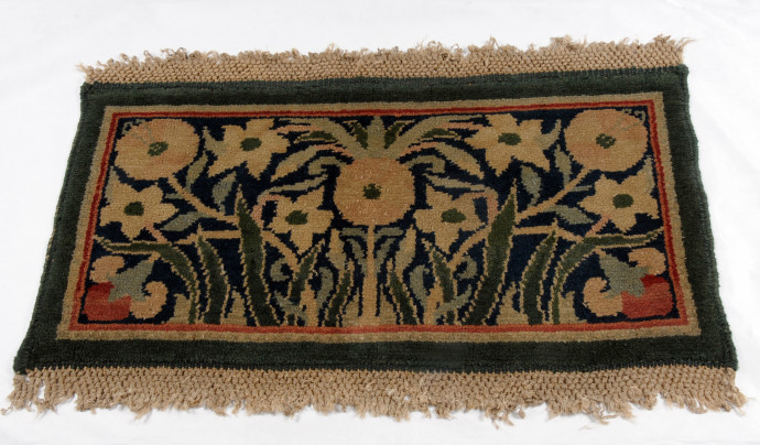 small fringed rug with flower design