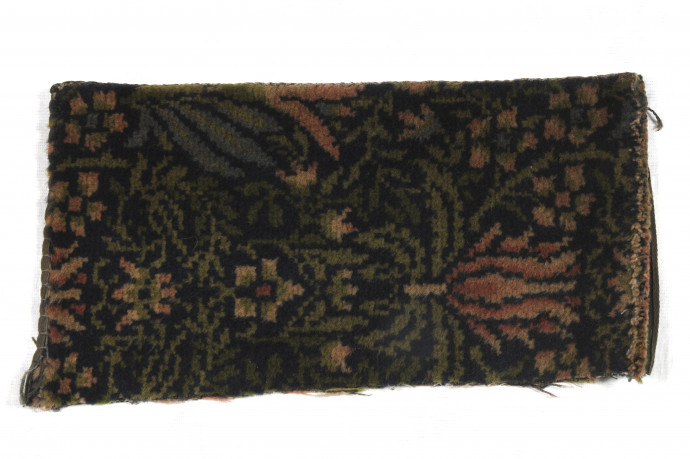 fragment of carpet with pink lilly on dark ground