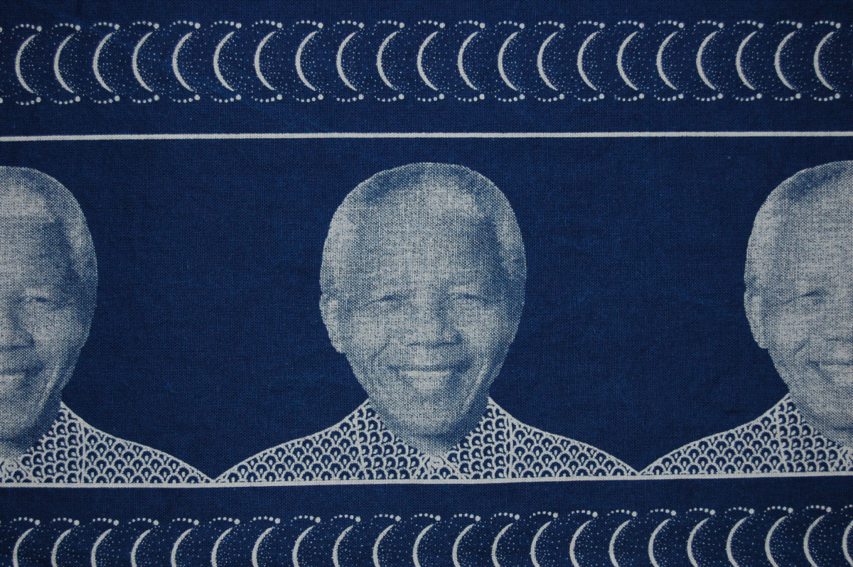 Repeating pattern on fabric showing a smiling Nelso Mandela